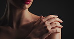 Beauty, hand and shoulder of woman on black background for aesthetic dermatology or cosmetics. Body, skincare and touching with model in dark studio for cosmetology routine, treatment or wellness