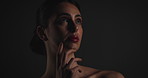 Woman, thinking and makeup in studio with results, mockup space and reflection on black background. Girl, beauty and perspective with transformation, cosmetics and red lips with glow with low angle