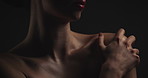 Hand, shoulder and skincare with woman on black background for aesthetic dermatology or cosmetics. Beauty, body and touching with model in dark studio for cosmetology routine, treatment or wellness
