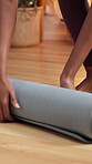  Closeup, hands and rolling yoga mat, home and done with workout, wellness and fitness in apartment. Healthy, person and finished with morning routine, floor and exercise for self care in house