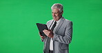Mature man, anchor and tablet in studio for reading notes, breaking news and reporting script. Mockup space, male person and digital of research, media information and review feedback on green screen
