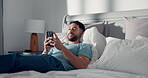 Smile, phone and reading with man in bedroom for social media, text message update and relax. Online news notification, morning and network with person in home for communication app and chat