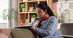 Notebook, planning and relax with woman on sofa in living room of home for diary or journal entry. Notes, planner and writing with person in apartment for ideas, memories or personal goals on weekend