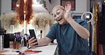Drag artist, person and phone with makeup, happy and wave with contact, video call or chat on web. LGBTQ influencer, smile and live streaming with cosmetics, excited and social media in dressing room