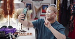 Drag artist, person and selfie with makeup, happy and beauty with peace sign with post on web. LGBTQ influencer, emoji and photography with cosmetics, profile picture or social media in dressing room