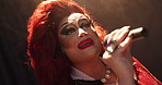 Singing, drag artist and person with mic for performance, creative show and lgbtq event. Singer, theater culture and performer with self expression for karaoke, talent and musical entertainment