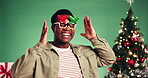 Christmas, frame and man with smile, dancing and excited for celebration, festive season and studio. Green background, face and happy for December holiday, rhythm or black person with xmas sunglasses