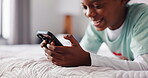 Hands, morning and phone with black child on bed in home for browsing, gaming or social media. App, relax and smile of happy African boy in bedroom of apartment for mobile communication or streaming
