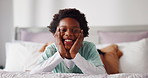 Face, relax and laugh with African kid in bedroom for calm, comfort or peace in morning in house. Portrait, black boy and child on bed in home for rest, funny or weekend break with happiness in Kenya