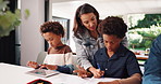 Help, mother and education with children for writing lesson, talk and study in homeschool. Brothers, parent and elearning with book for homework, tablet and teaching African students in family home