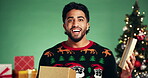 Christmas, present and surprise with face of man in studio for celebration, promotion and holiday season. Wow, festive event and xmas vacation with person on green background for December gift box