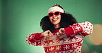 Dance, Christmas and celebration with woman and sunglasses for glitter, holiday season and energy. Festive event, bokeh and happiness with person on green background studio for xmas and December
