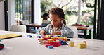 Building blocks, learning and puzzle with boy in home for child development, education or game. Problem solving, wooden toys and motor skills with kid in family house for geometric object and playing