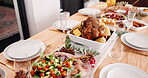Table setting, food and holiday with dinner for party in house, roast meal with chicken and vegetables for Christmas. Gourmet cuisine, arrangement for feast or supper with Thanksgiving event at home