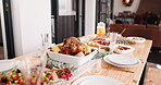 Table, food and holiday with dinner for party in house, roast meal with chicken and vegetables for Christmas. Gourmet cuisine, place setting or arrangement for feast with Thanksgiving event at home