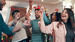 Christmas, sparklers and friends in home for party, celebration or event in festive season together. Happy, fireworks and group of excited people dancing for xmas holiday with reunion in apartment.