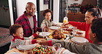 Happy family, christmas and praying with food at dining table for festive feast together in home. Parents, children or holding hands with gratitude for faith, meal or thanksgiving dinner in house