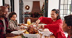 Christmas, family and mother cutting chicken with kids in home for serving lunch with father. Xmas, happy parents and meal with children for holiday celebration, festive food or hungry African people