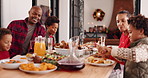 Christmas, parents and eating lunch with children, talking and happy in family home. Xmas, father and mother with kids for food, holiday celebration and pour juice with hungry African people together