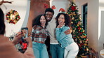 Christmas, hug and photograph with people in living room of home together for celebration or memories. Festive, profile picture and social media with happy friends embracing in apartment for holidays