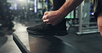 Hands, shoes and tie laces in gym for fitness, run or start exercise routine with man for health. Person, athlete and ready for workout, training or sports with sneakers for preparation at club
