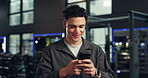Smile, athlete and man with phone at gym for social media, fitness app and sign up on website. Happy, male person and mobile for research, review progress and online notification of sports membership