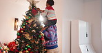 Father, child and carry with decoration for Christmas, festive celebration or holiday tradition. Smile, man and kid with ornaments, help and flare for family bonding and prepare xmas season in home