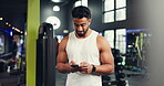 Athlete, man and reading with phone at gym for social media, fitness app and sign up on web. Happy, male person and mobile for research, review progress and online notification of sports membership