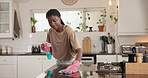 Black woman, cleaning and kitchen with spray for hygiene, disinfection or anti bacteria in home. Female person, wiping and surface with cloth or detergent for housekeeping, germ or dirt removal