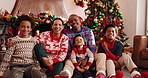 Face, family and celebration of Christmas, home or bonding on festive season, laughing and December. Happy, man and woman with children on Xmas holiday, tickling and fun with kids, lounge and house