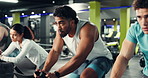 Sports, cycling class and group of people in gym for cardio workout, training or challenge together. Breathing, man and athletes on stationery bicycle for spinning exercise in fitness center.
