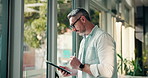 Creative, online and man with tablet, office and inspiration search for interior design or browsing. Business, designer and mature person with tech for remodeling project, planning or ideas on web