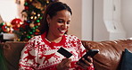 Credit card, Christmas and woman on sofa with phone for online shopping, festive season and deals. Debit, cellphone and female person with internet store, xmas discount and gift in home living room