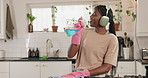 Black woman, dancing or kitchen with headphones for cleaning, hygiene or fun energy in home. Female person, wiping or singing with cloth or detergent for music, vibe or germ and dirt removal in house