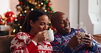 Christmas, coffee and African couple with laugh, tree and love in living room of house together. Joke, smile and man with woman, xmas and holiday or vacation bonding for festive season or tradition