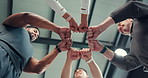 People, fitness and fist bump with team below for unity, solidarity or active mission in gym. Low angle, group or community with hands together in huddle for synergy, cohesion or trust in health club