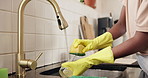 Hands, washing dishes and woman in kitchen, home and water with hygiene, chore and tap. Closeup, housekeeping and person with faucet, stop bacteria and cleaning with gloves, safety and routine