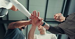 Happy people, fitness and team with hands together or applause below for winning or success in gym. Low angle, group or community clapping with pile or stack in huddle for achievement in health club