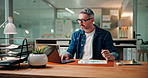Data, laptop and research with business man in office at night for sales performance, schedule and report. Project update, feedback stats and overtime with mature person in agency for review