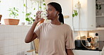 Health, medicine and black woman drinking water for wellness, healing or prescription treatment. Person, medication and glass with pills for magnesium supplements or medical drugs in home kitchen
