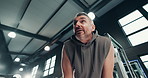 Below, tired and mature man at gym for fitness, intense exercise and break from workout. Male person, breathing and exhausted with sweat, cardio training and burnout recovery from endurance challenge