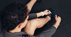 Above, man and tie shoes in gym for fitness, run or start exercise routine with laces for health. Person, athlete and ready for workout, training or sports with sneakers for preparation at club