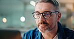 Business, man or laptop in office at night for system design, writing code or software development. Developer, mature person or thinking with glasses reflection for solution process or ideas for HTML