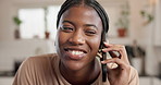 Happy, black woman and talking with phone call in kitchen for funny conversation or chat in home. Female person, user or speaking with smile on mobile smartphone for friendly discussion in house