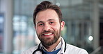 Doctor, face and man with smile in hospital for medical service, health support or medicare pride. Medicine, cardiologist or happy in clinic for healthcare work, about us, trust or proud professional