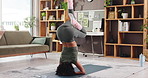 Woman, yoga and headstand in home, meditation and balance for circulation, brain or benefit in lounge. Person, sirsasana and back with routine on floor for mindfulness, zen or stretching at apartment