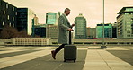 Luggage, phone and walking with businessman in city for international travel or trip abroad. App, commute and suitcase with mature corporate employee outdoor in urban town for airport flight schedule