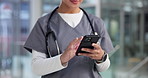 Woman, nurse and hands with phone for medical research, information or telehealth app in hospital. Female person, admin or clinic assistant scroll with mobile smartphone for schedule or appointment