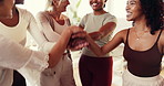 People, group and stack hands at pilates class for celebration, goals and motivation at fitness club. Women, circle and happy for exercise course, excited or cheers with applause at wellness studio