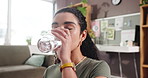 Drinking water, medication or supplements with woman in living room of home for daily vitamins. Glass, pills or tablets with person in apartment for benefits of routine treatment or wellness
